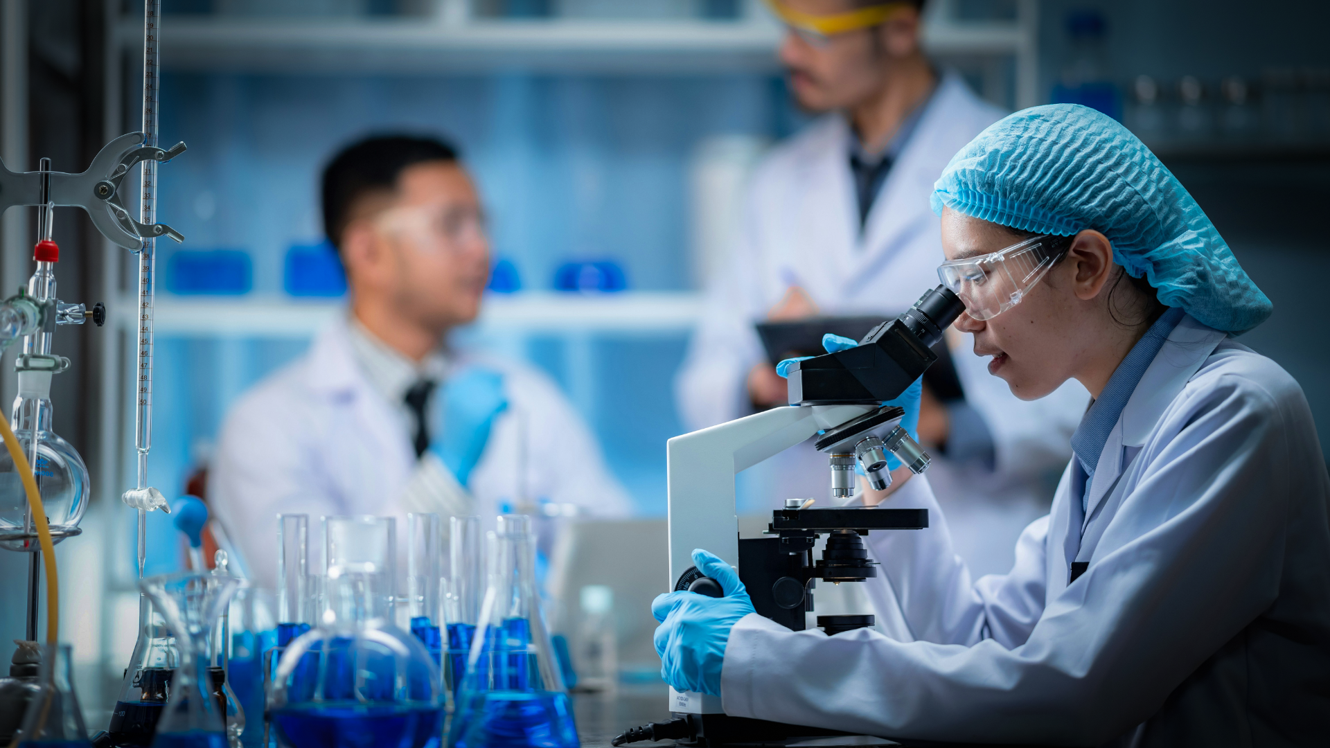 scientist looking through a microscope